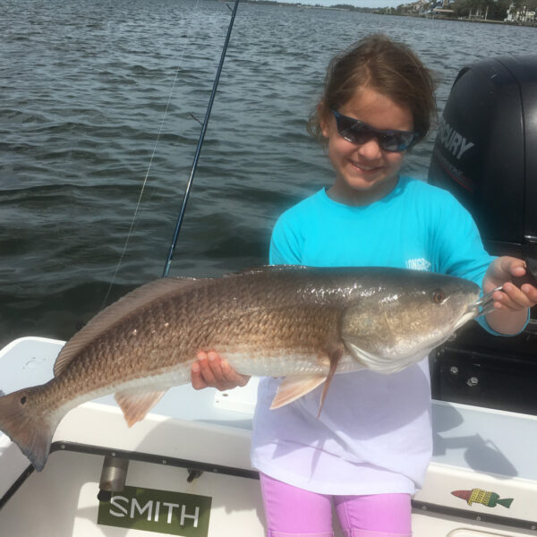 kid_grinning_with_redfish_winter